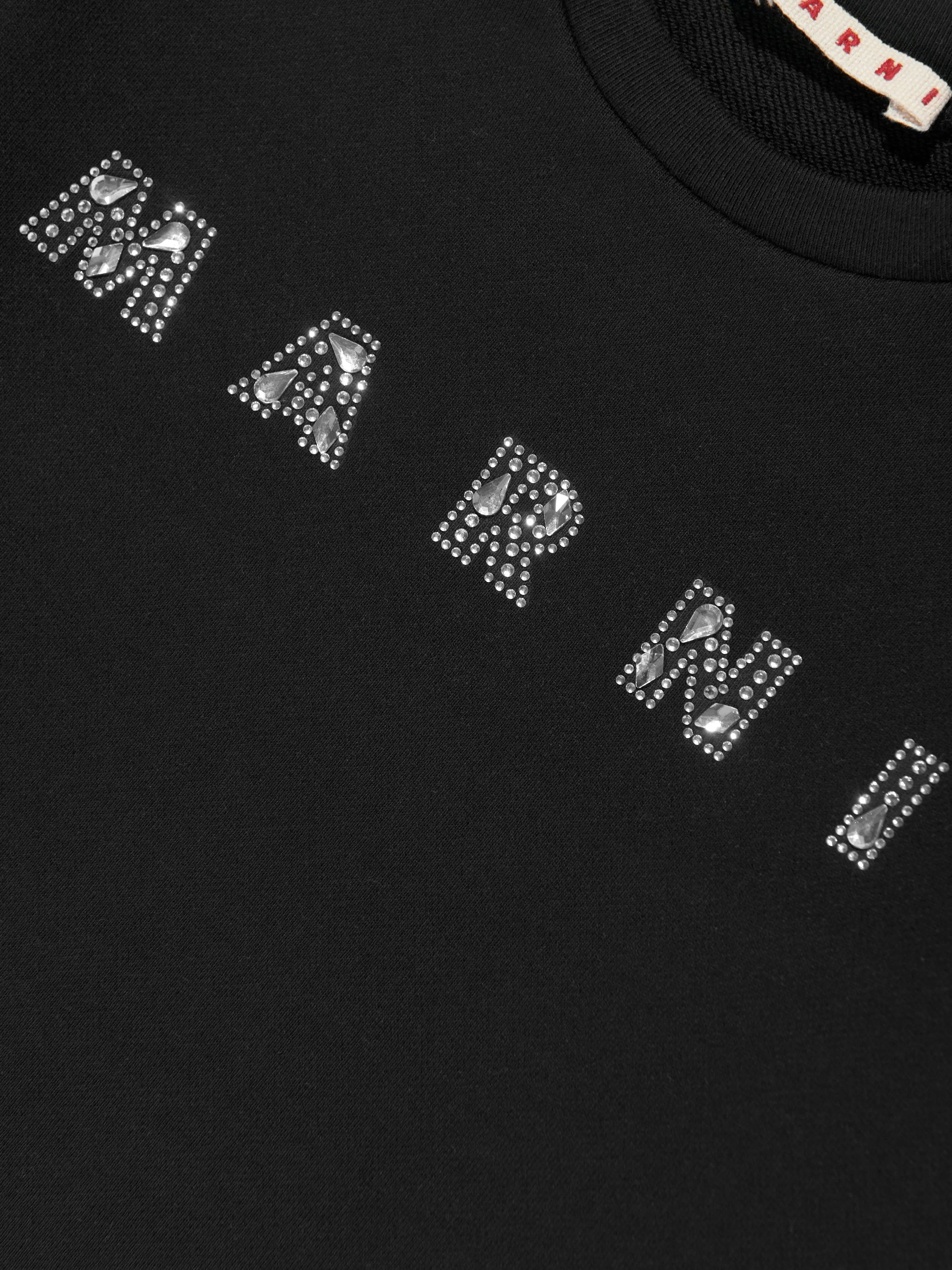 Mädchen Sweatshirt mit Logo aus besetzten Steinen in Schwarz